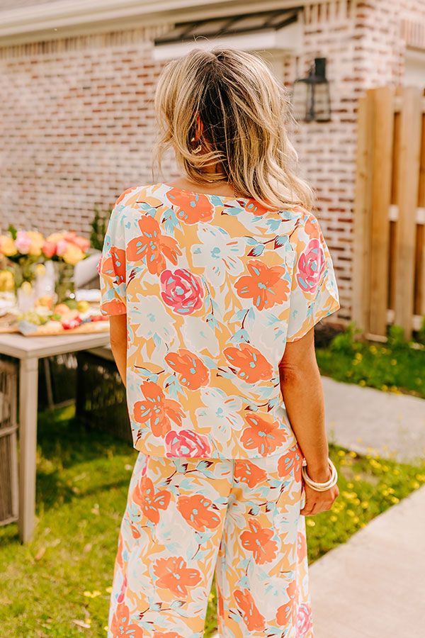 - Spend hot summer days and sweet summer nights in luxe style with this breezy top! - Unlined semi-sheer material with a blue, pink, and orange hued floral print - A round neckline - Short sleeves - A relaxed silhouette that ends in a straight hemline Peach Tops For Summer Brunch, Bohemian Floral Print Tops For Loungewear, Breezy Tops For Summer Loungewear, Vacation Floral Print Crew Neck Blouse, Summer Floral Print Crew Neck Blouse, Vacation Crew Neck Blouse With Floral Print, Summer Crew Neck Top For Brunch, Floral Print Crew Neck Blouse For Beach, Floral Print Crew Neck Blouse For Vacation