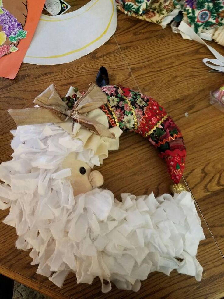 an animal made out of toilet paper sitting on top of a wooden table next to other items