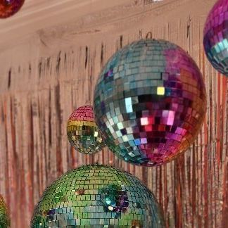 several disco balls are hanging from the ceiling