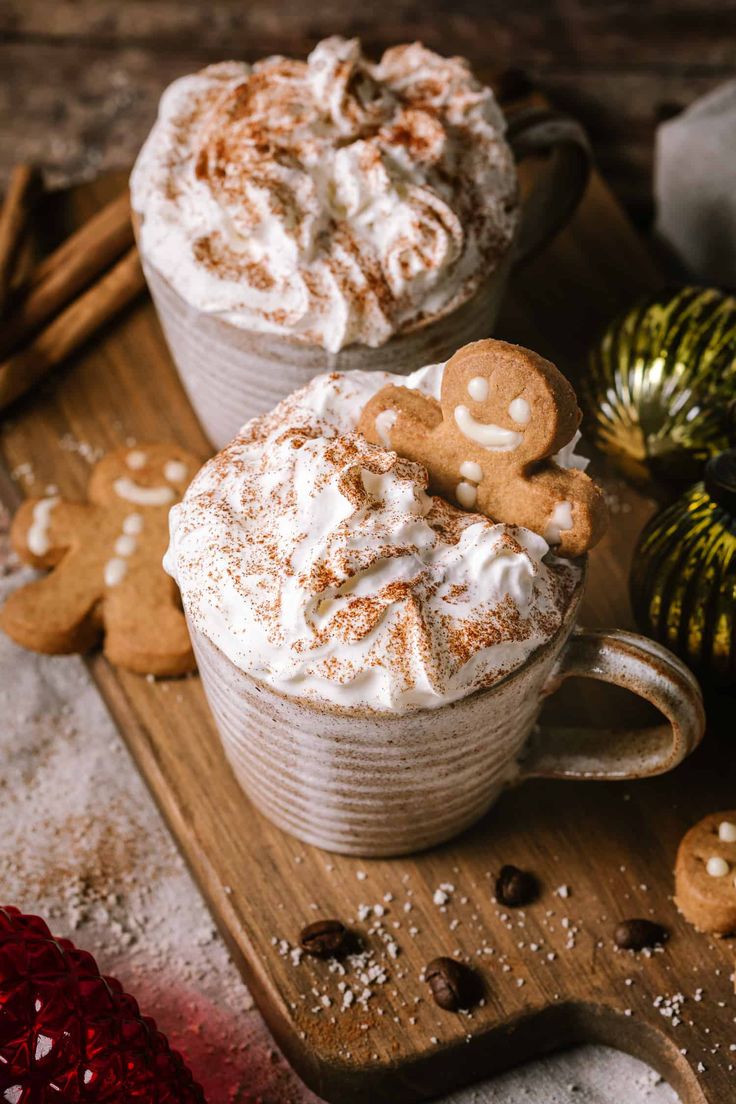 two mugs filled with hot chocolate and marshmallow cookies