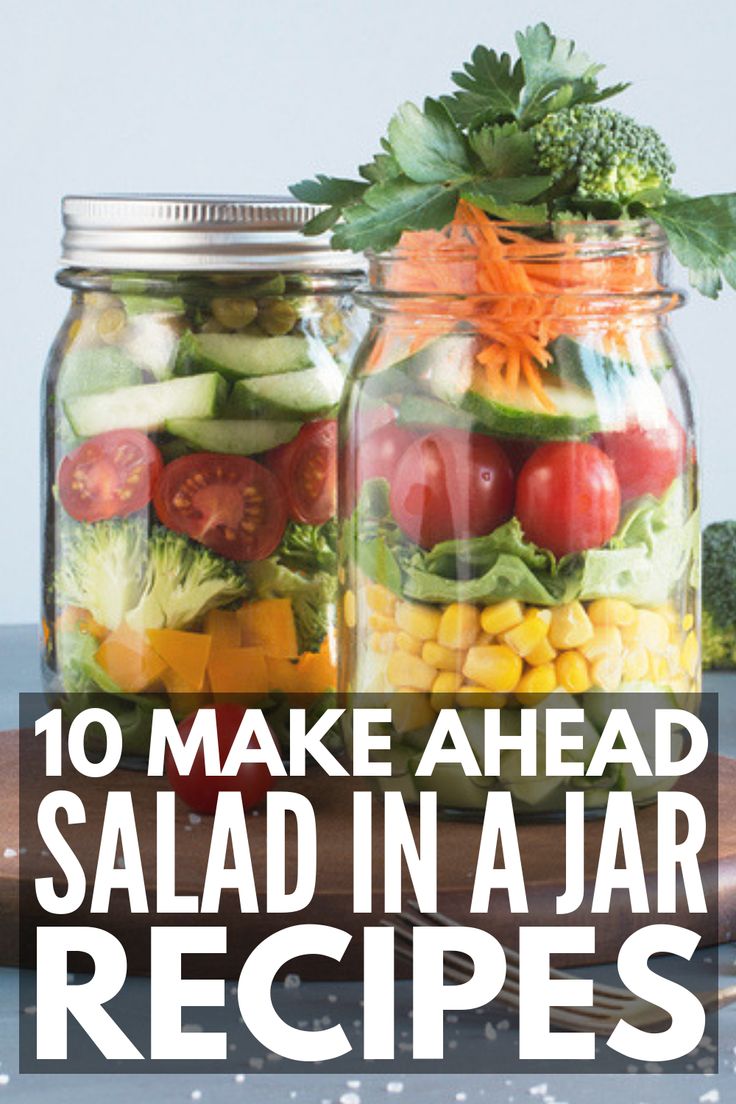 two mason jars filled with salads and vegetables