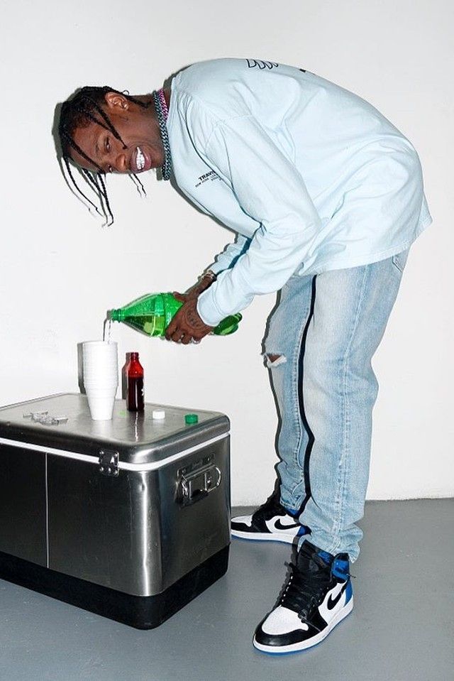 a man standing next to a cooler filled with drinks