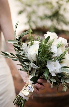 a bride holding a bouquet of white flowers