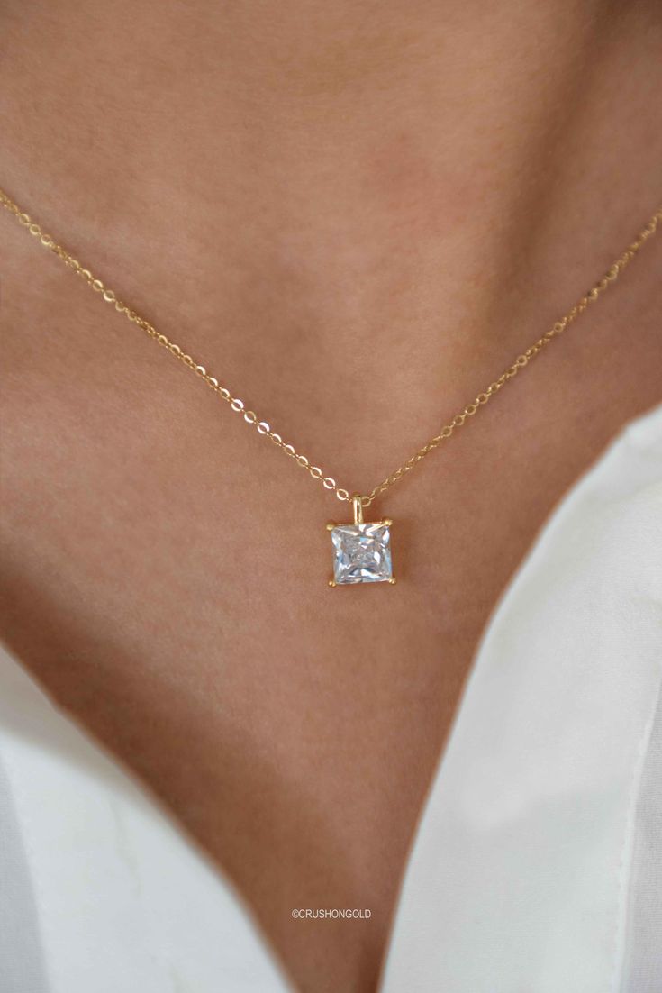 This elegant Princess Cut Solitaire Diamond Necklace is crafted with a high-grade simulated diamond and is plated with 14k gold on sterling silver. It is finished with an anti-tarnish coat and an e-coat for long-lasting preservation of the plating. It's a perfect addition to your jewelry collection and makes a great gift for birthdays, graduations, or for your best friend. PRODUCT DETAILS: * Necklace Length is Adjustable from  15. 5 inches to 17.5 inches with 2 inch of extenders * Comes with 2 i Princess Cut Solitaire Necklace Fine Jewelry Gift, Princess Cut Solitaire Necklace For Gift, Princess Cut Solitaire Necklace As Gift, Princess Cut Solitaire Necklace Fine Jewelry, Princess Cut Diamond Solitaire Necklace Gift, Fine Jewelry Princess Cut Cubic Zirconia Necklace, Princess Cut Solitaire Diamond Necklace As A Gift, Classic Cubic Zirconia Princess Cut Necklace, Fine Jewelry Cubic Zirconia Princess Cut Necklace