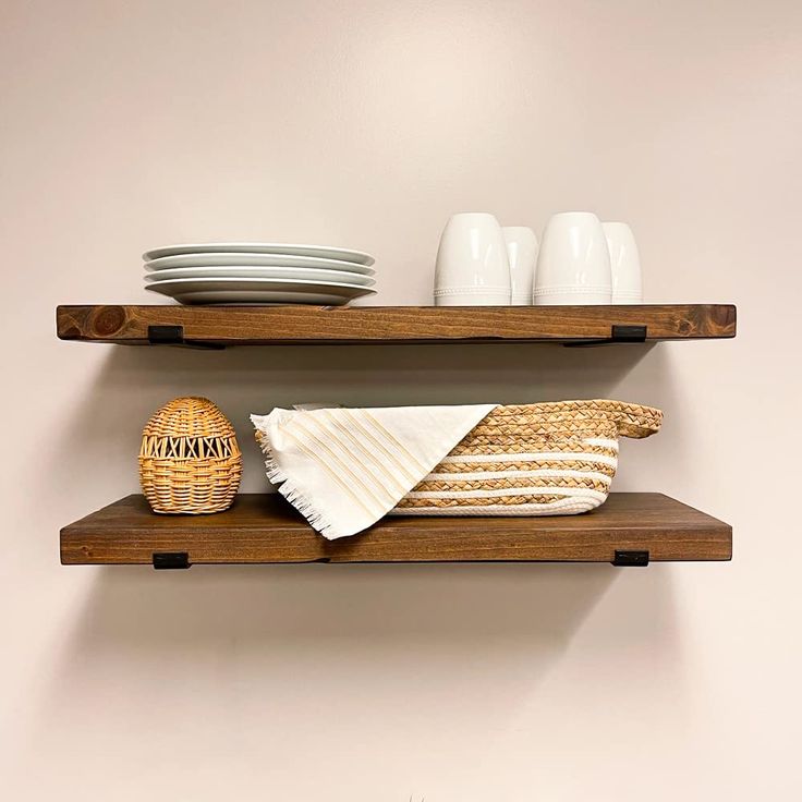 two wooden shelves with plates and bowls on them