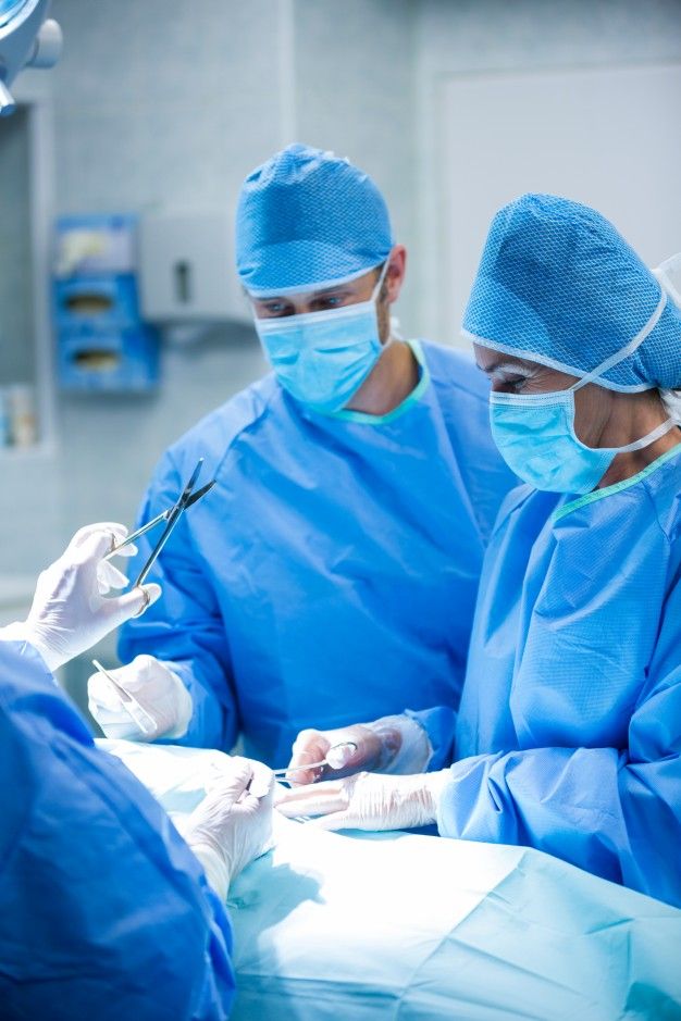 two surgeons are performing surgery in an operating room