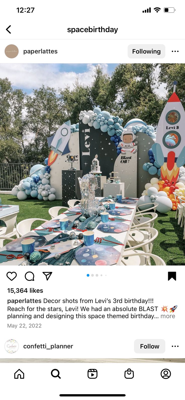 an instagramted photo of a birthday party with balloons and rocket ship decorations on the lawn