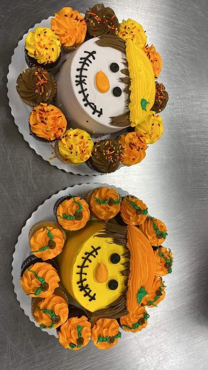 two decorated cupcakes sitting on top of each other