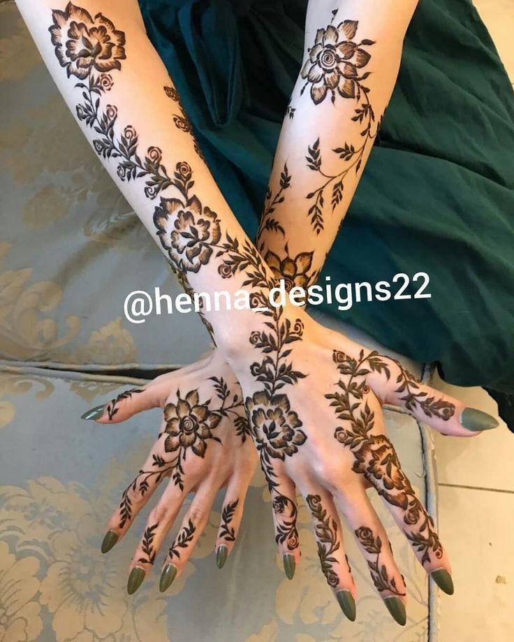 two hands with henna designs on them