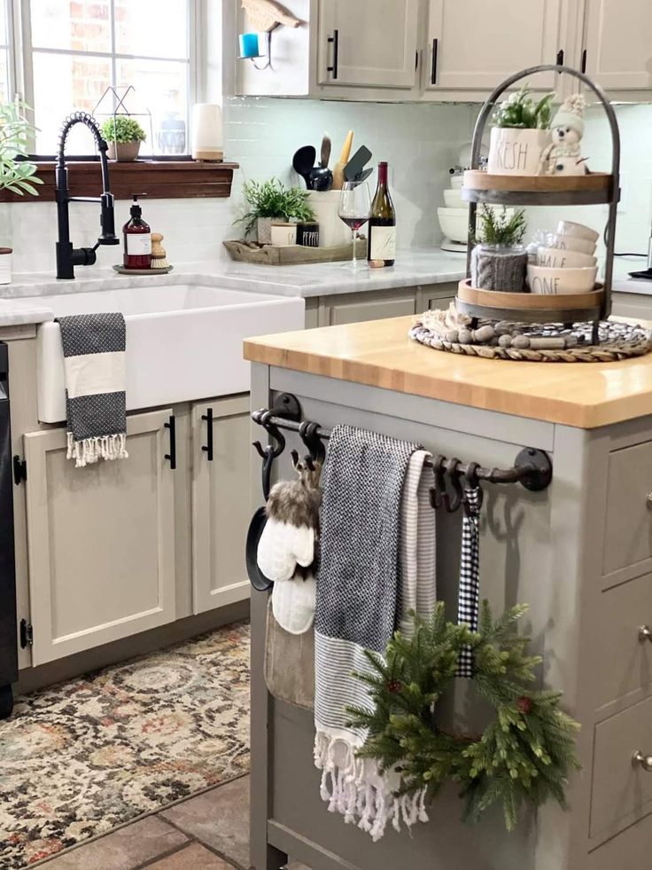 a kitchen filled with lots of counter space and decorations on top of the island in front of the sink