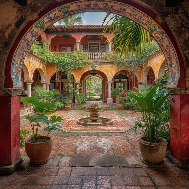 an archway leading into a courtyard with potted plants