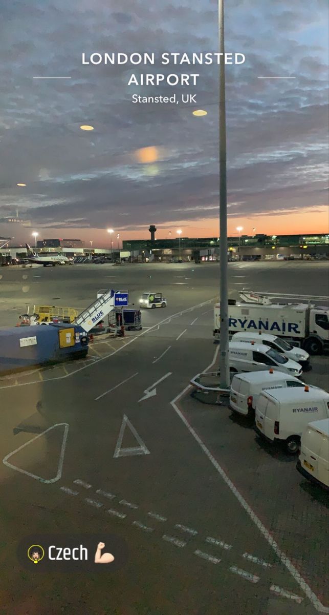 an airport parking lot with airplanes parked in it