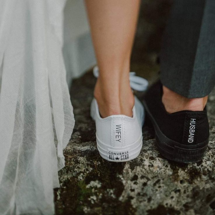 a bride and groom's feet in white slip on shoes with the word wed written on them