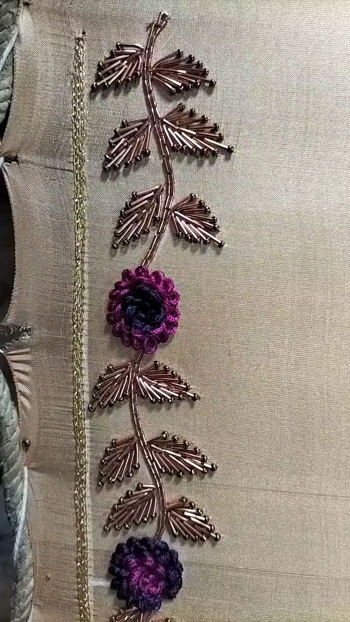 a close up of a decorative pillow with flowers on it's side and chains hanging from the back