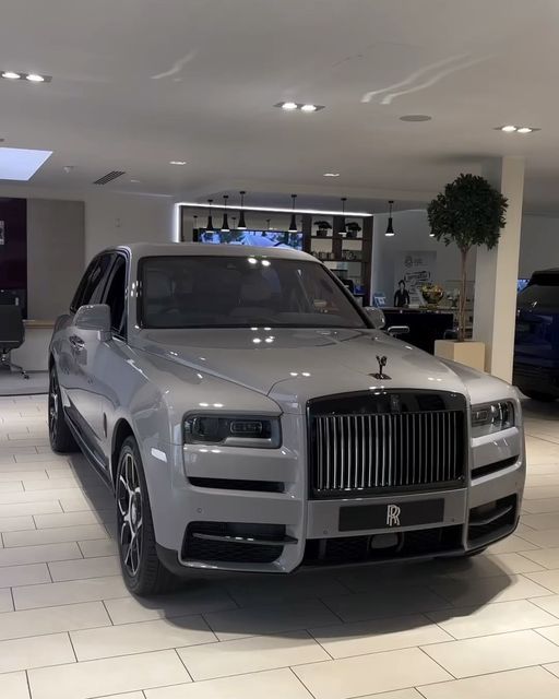 a silver car is parked in a showroom