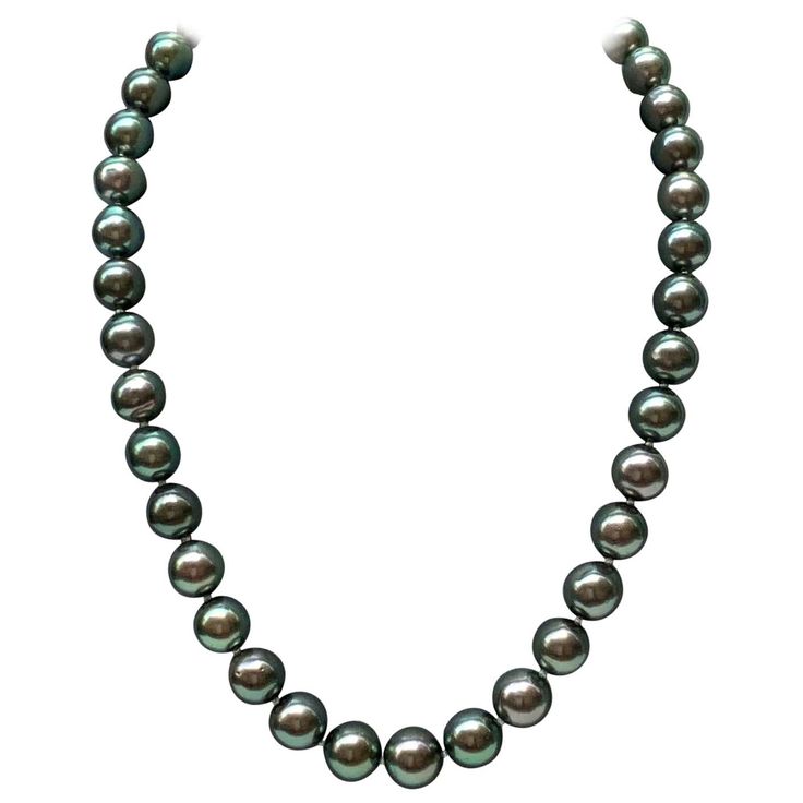 This gorgeous pre-owned green Tahitian South Sea pearl graduated necklace features 39 pearls carefully chosen for their radiant luster and green overtone. Their sizes range from 9-11mm It is a Princess length as follows: - Pearl to pearl: 42 cms - approx. 16.6" - Including clasp: 44 cms - approx. 17.3" Clasp: white gold Stamp: Switzerland Condition: As new All items at la Bourse du Luxe are subject to a strict quality control Green Pearl Necklace For Formal Occasions, Green Single Strand Pearl Necklace, Single Strand Green Pearl Necklace, Formal Green Pearl Necklace With Round Beads, Formal Green Pearl Necklace, South Sea Pearl Necklace, Tahitian Pearl Necklace, Pearl Strands Necklace, Graduation Necklace