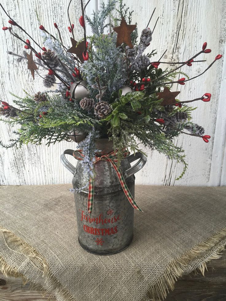 an old fashioned metal milk can with christmas decorations in it