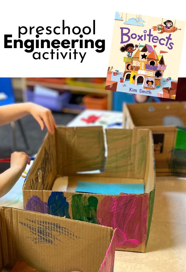 two children are playing with cardboard boxes on the table