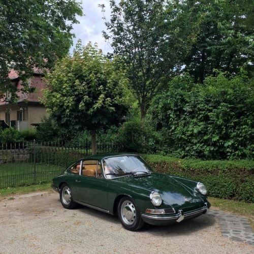 a green car parked in front of a house