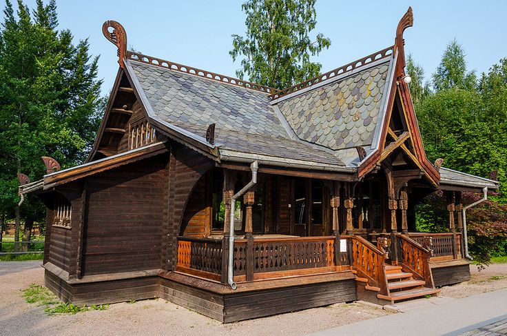 an old wooden building with a roof made of shingles and wood trimmings