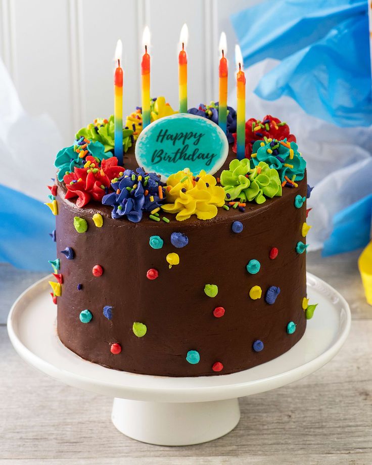 a birthday cake with chocolate frosting and colorful sprinkles