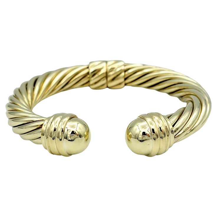 The David Yurman Cable Classics cuff bracelet, crafted in luxurious 14 karat yellow gold, is a timeless and iconic piece of jewelry. Its design features the brand's signature twisted cable motif, showcasing meticulous craftsmanship and attention to detail. This intricate cable pattern adds texture and dimension to the bracelet, creating a striking and distinctive look. Equipped with a convenient hinge mechanism, the bracelet allows for easy on and off, providing both comfort and practicality. The combination of high-quality materials and expert craftsmanship ensures that this piece not only exudes elegance but also withstands the test of time. Whether worn alone as a statement piece or stacked with other bracelets for a layered look, the David Yurman Cable Classics cuff bracelet is a versa Cable Pattern, The David, Gold Collection, David Yurman, Layered Look, Stylish Accessories, Cuff Bracelet, Hinges, Design Features