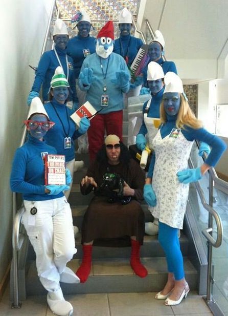 a group of people dressed in costumes posing on an escalator