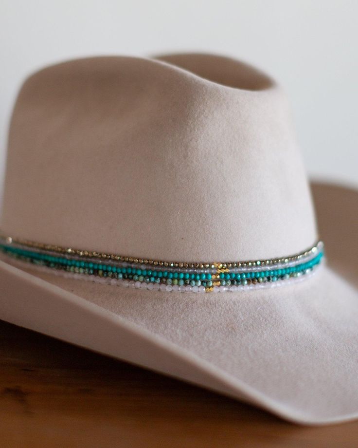 The more delicate version of our beaded hat band - the petite beaded hat band features a variety of semi-precious faceted gemstones with leather ties for an adjustable closure to fit any hat. Dimensions: 20" beaded length before leather ties Material: Various Semi-Precious Stones/Beads, Leather Cording Hardware: Gold Plated Jump Rings and Crimp Beads Closure: Leather Ties - brown for all stone options except pyrite, which uses black Stone Options: African TurquoiseTurquoiseLabradoritePyriteRose Western Style Adjustable Beaded Jewelry, Adjustable Bead Cap Hat Bands For Festival, Adjustable Southwestern Turquoise Hat Bands, Adjustable Hat Band With Bead Caps For Festival, Adjustable Beaded Fedora Hat Band, Southwestern Beaded Turquoise Hat Bands, Southwestern Turquoise Beaded Hat Bands, Adjustable Turquoise Hat Bands For Country Events, Adjustable Beaded Hat Bands For Country Events