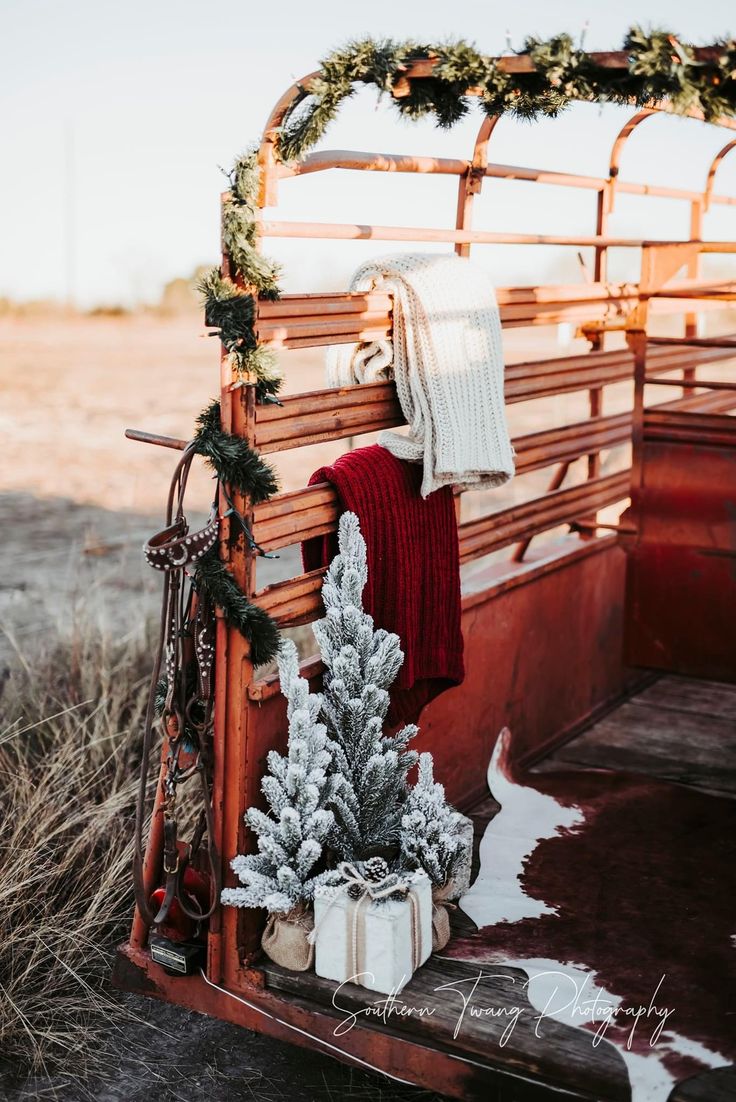 an old truck with christmas decorations on the back