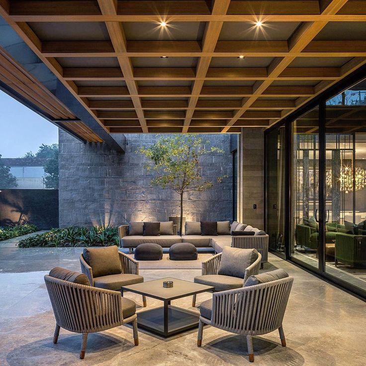 an outdoor living area with couches and chairs