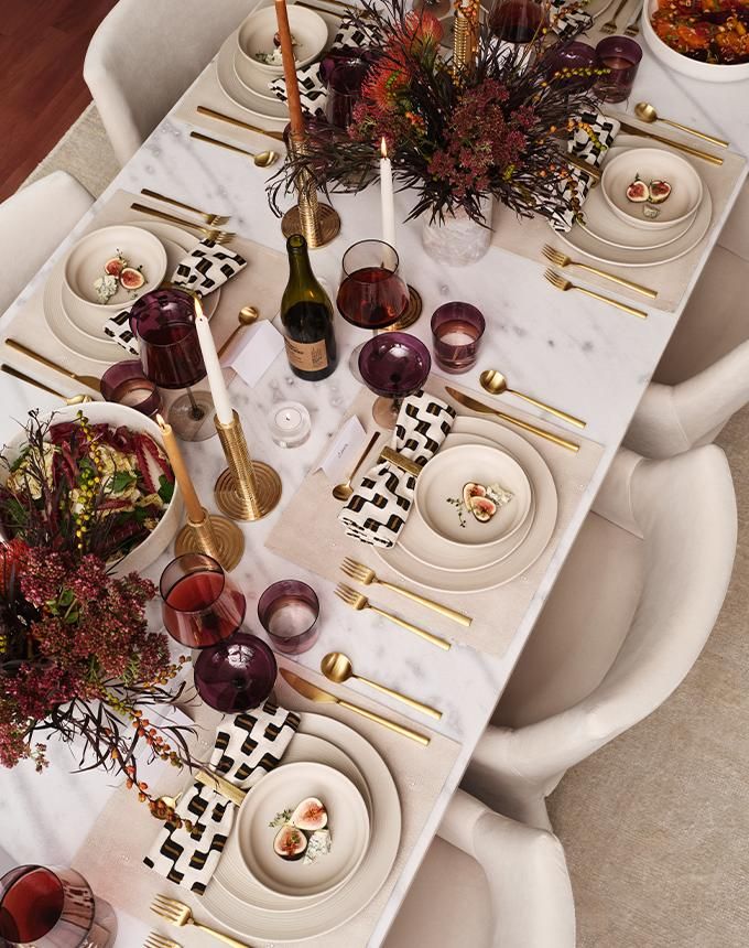 the table is set with dishes and place settings