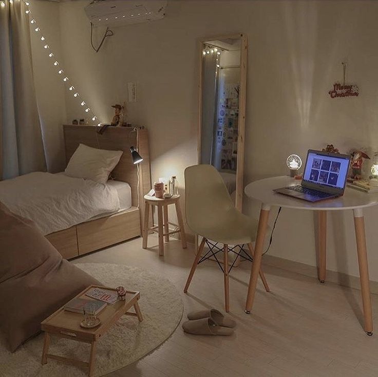 a laptop computer sitting on top of a white table in a room filled with furniture