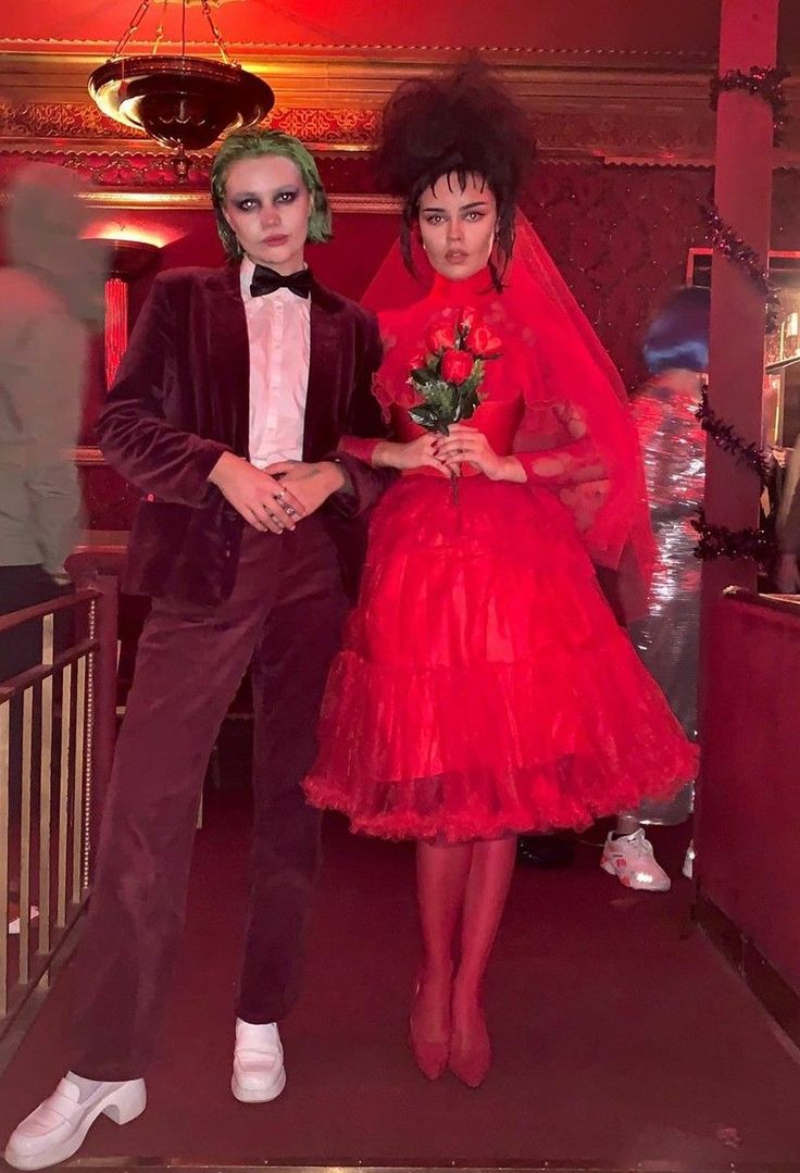 two people dressed up in costumes standing next to each other