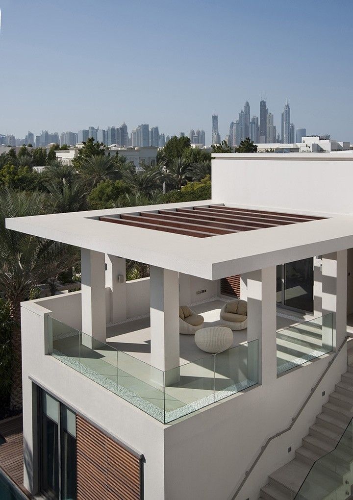 a modern house overlooking the city with stairs leading up to it's second floor