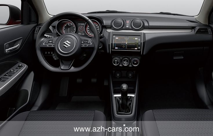 the interior of a small car with dashboard controls and steering wheel, along with dash lights