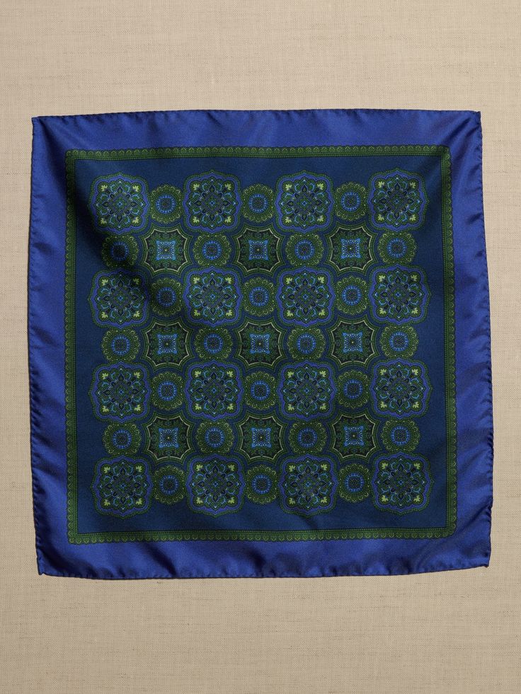 This refined pocket square is made from luxe silk for a pop of sheen color on your suit jacket.  Height: 13" (33cm) Width: 13" (33cm) Green Formal Pocket Square Handkerchief, Formal Green Pocket Square Handkerchief, Elegant Blue Silk Pocket Square, Formal Rectangular Silk Scarf, Silk Pocket Square For Business, Blue Rectangular Pocket Square For Formal Occasions, Elegant Blue Rectangular Handkerchiefs, Classic Blue Silk Pocket Square, Luxury Square Silk Scarf For Formal Events