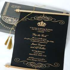 a black and gold wedding card with tassels