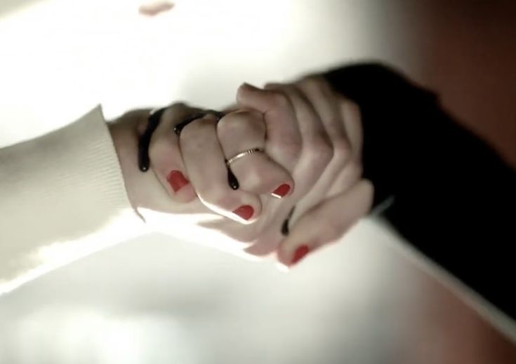 two hands holding each other with their fingers