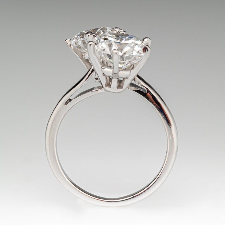 a three stone diamond ring on a white background