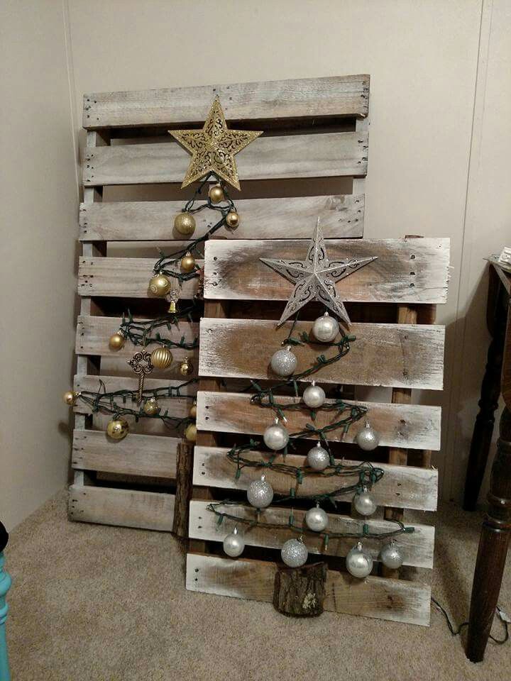 a christmas tree made out of wooden pallets with ornaments on the top and bottom