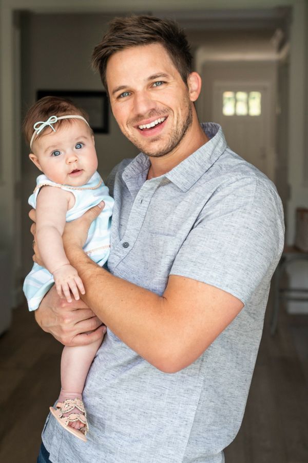 a man holding a baby in his arms