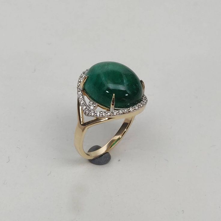 **KINDLY CHECK OUT THE VIDEO OF THE ITEM FOR A CLEARER VIEW**Video of the original ring is available on the following IG link: https://www.instagram.com/p/B0WH28Rn1u-/?igshid=qyga99wyh1xz Details of the ring Gemstone: Diamond Gem shape & weight: Round, ( 40 piece ) & 0.31 carats Emerald cabochons oval (1 piece) Weight: 11.03 carats Metal: GOLD Purity: 14 KT Weight: 3.34 Grams Total weight of the ring: 5.61 grams US Ring size 7 Beautiful fine cut Natural Diamond VVS-VS PURITY & I-J co Unique Formal Ring With Accent Stones, Formal Round Gemstones With Gemstone Accents, Unique 14k Gold Rings With Gemstone Accents, Luxury Emerald Ring, Unique Polished Gemstones For Formal Occasions, Unique Formal Gemstones With Polished Finish, Luxury 14k Gold Rings With Gemstone Accents, Modern Emerald Ring With Diamonds, Formal Emerald Ring With Gemstone Accents