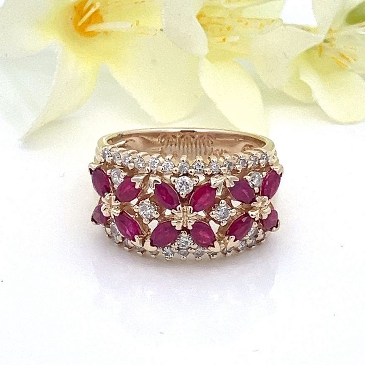 a close up of a ring with flowers in the background