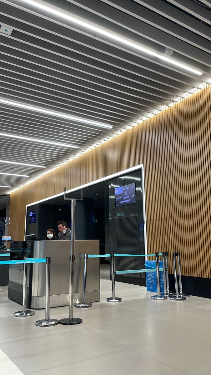 an airport lobby with people waiting for their luggage