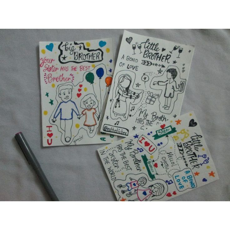 three notebooks with drawings and writing on them