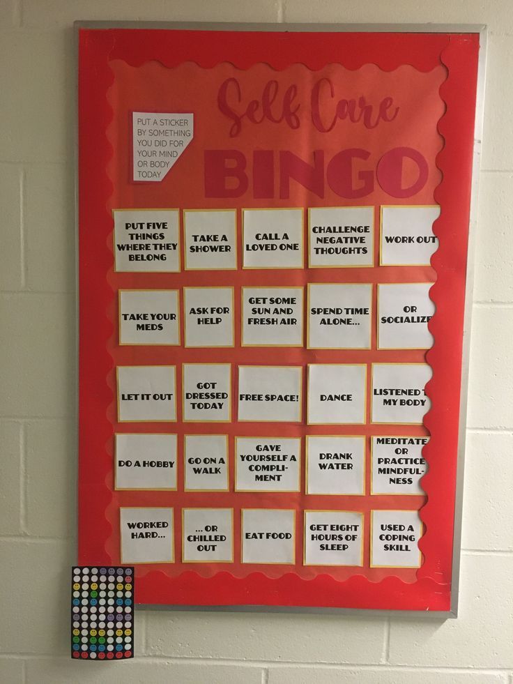 a red and white sign with words on it that says self care bingo next to two blocks of colored crayons