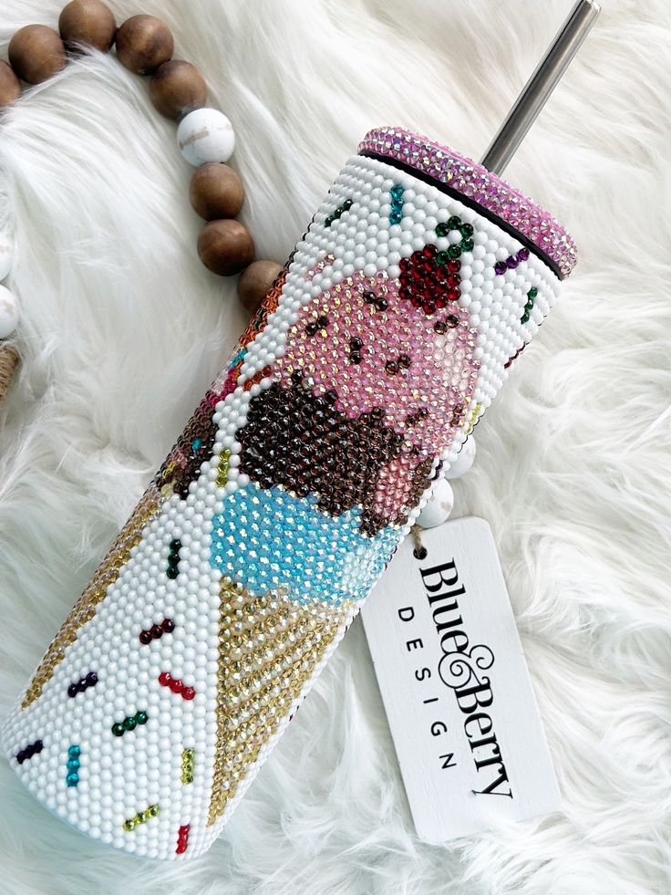 an ice cream cone beaded case on a white furnishing with a name tag