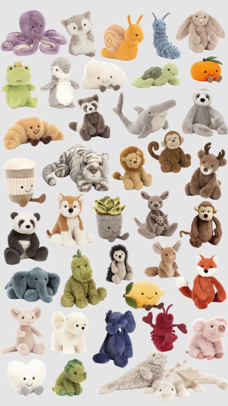 an assortment of stuffed animals sitting on top of each other in different colors and sizes