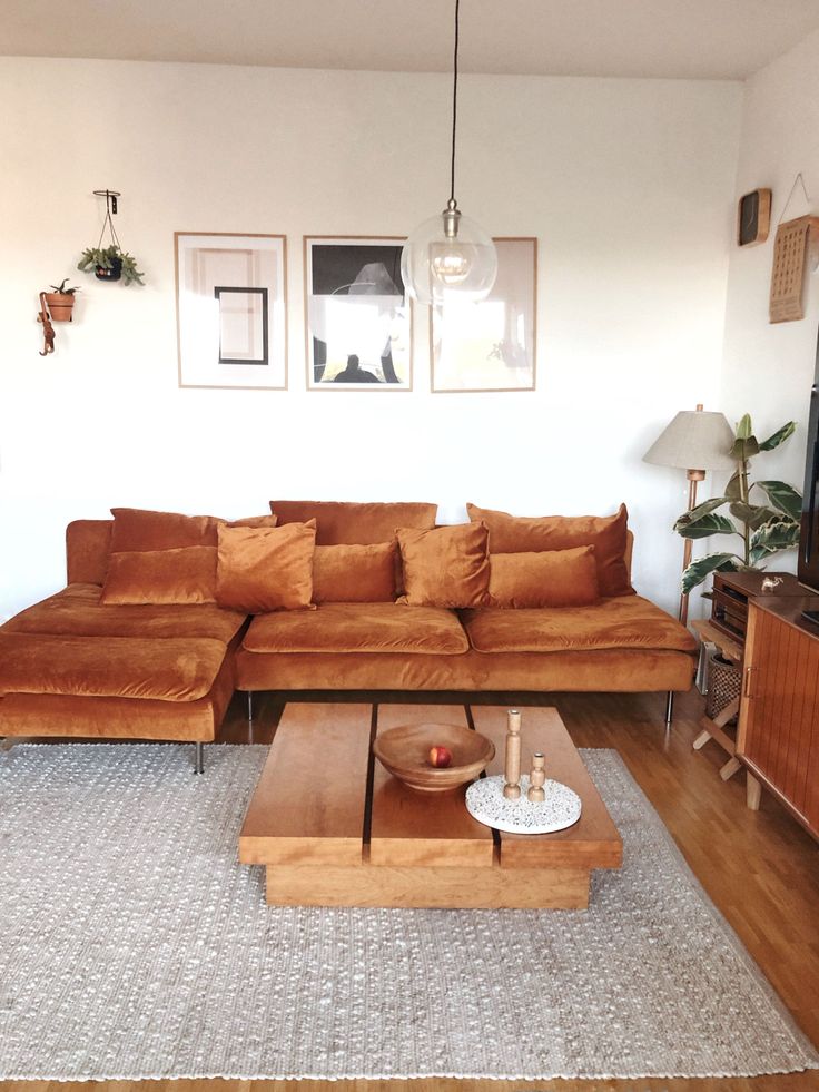 a living room with a couch, coffee table and television on top of the tv stand