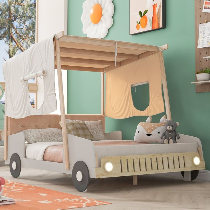 a child's bedroom with a canopy bed and toys